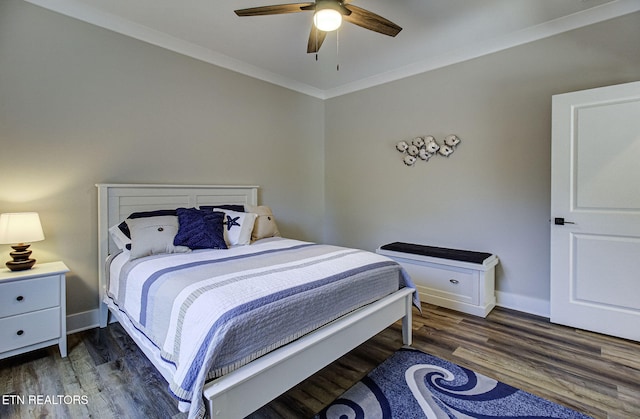 bedroom with crown molding, baseboards, and wood finished floors