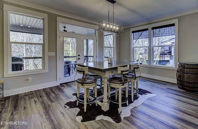 dining space featuring baseboards, visible vents, dark wood-type flooring, and french doors