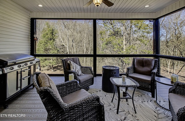 sunroom / solarium with ceiling fan and wooden ceiling