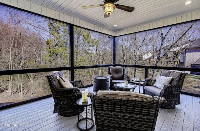 wooden terrace with ceiling fan and outdoor lounge area