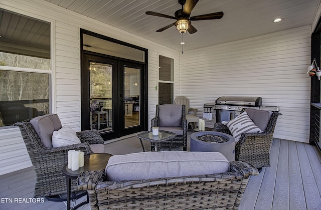 wooden deck featuring outdoor dining space, a grill, a ceiling fan, and french doors