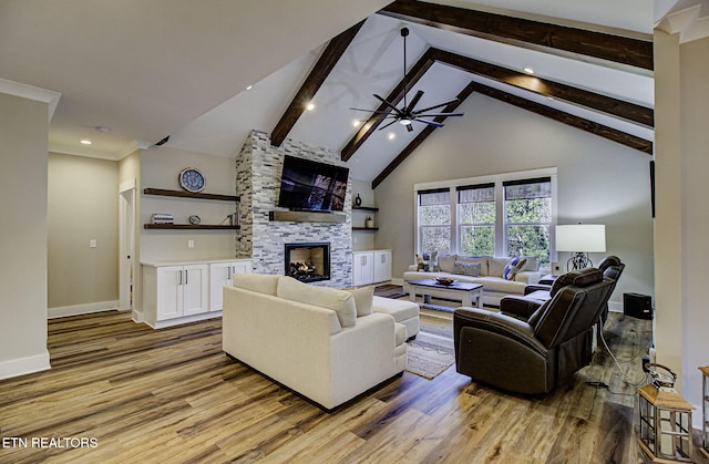 living room with baseboards, a stone fireplace, light wood-type flooring, high vaulted ceiling, and beam ceiling