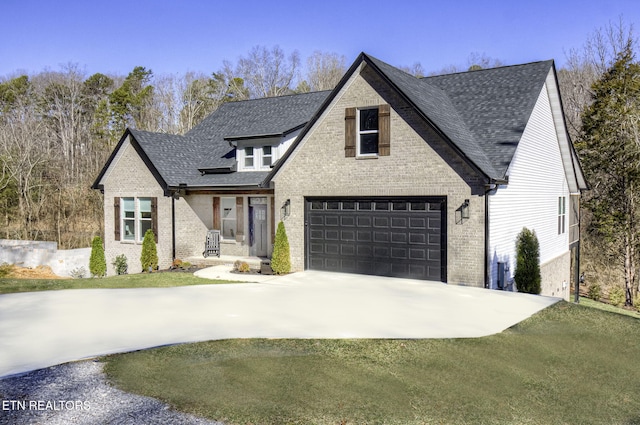 view of front of house featuring a garage, brick siding, driveway, and roof with shingles