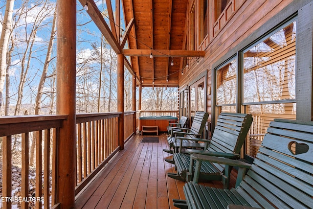 snow covered deck with a hot tub