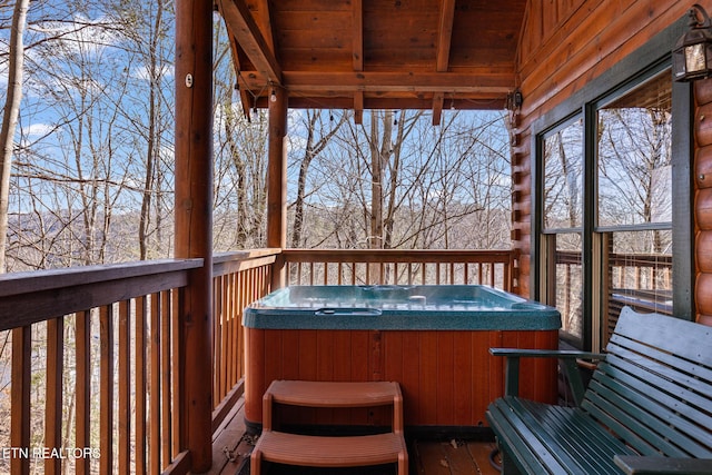 wooden deck with a hot tub