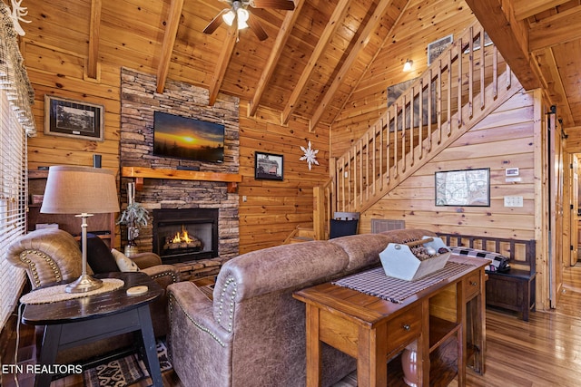 living room with wood-type flooring, wood ceiling, beam ceiling, and wood walls