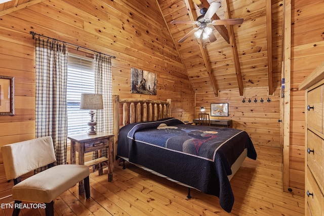 bedroom featuring wooden walls, vaulted ceiling with beams, wood ceiling, and light hardwood / wood-style flooring