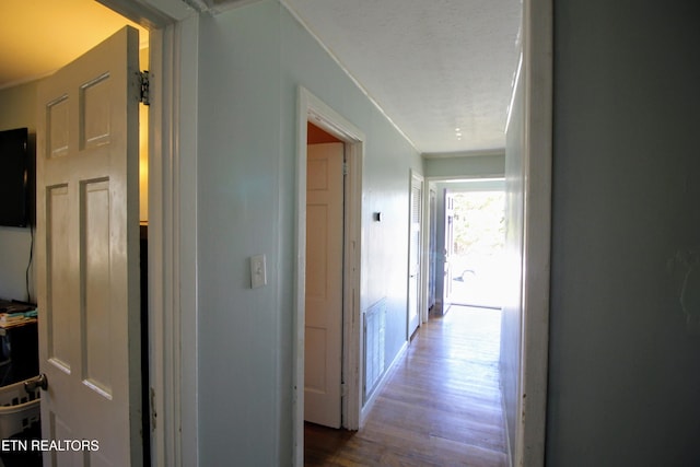 corridor featuring hardwood / wood-style floors