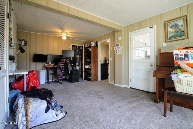 interior space with carpet flooring and ceiling fan