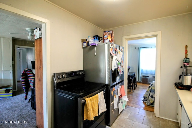 kitchen with white cabinetry, light tile patterned floors, ornamental molding, and appliances with stainless steel finishes