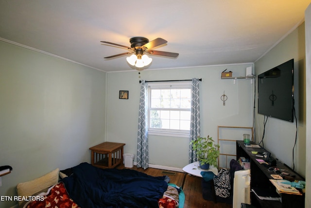 bedroom with crown molding, hardwood / wood-style flooring, and ceiling fan