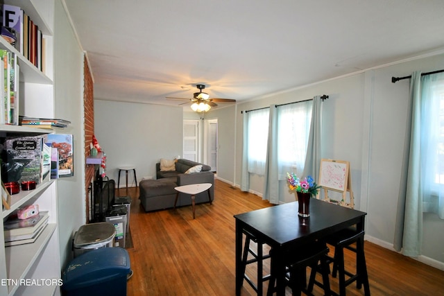 dining space featuring wood-type flooring and ceiling fan