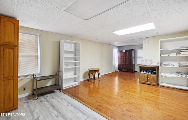 miscellaneous room with light wood-type flooring and a drop ceiling