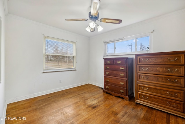 unfurnished bedroom featuring crown molding, ceiling fan, and wood-type flooring