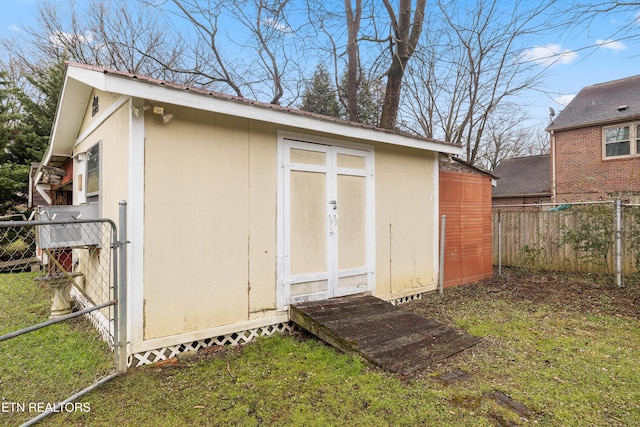 view of outbuilding featuring a lawn