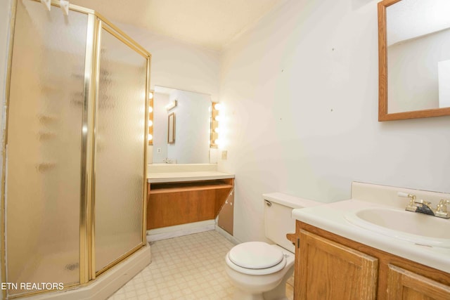 bathroom featuring vanity, an enclosed shower, and toilet