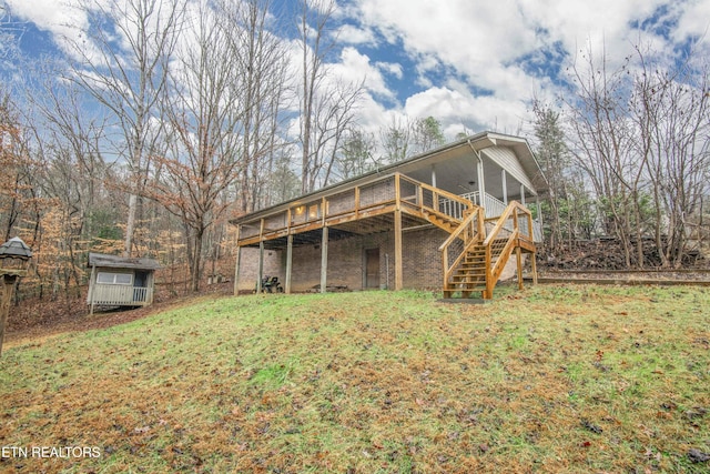 rear view of property with a lawn and a deck