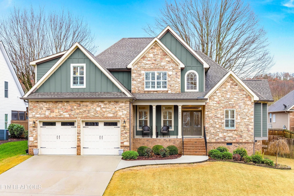 craftsman inspired home featuring a front yard and covered porch