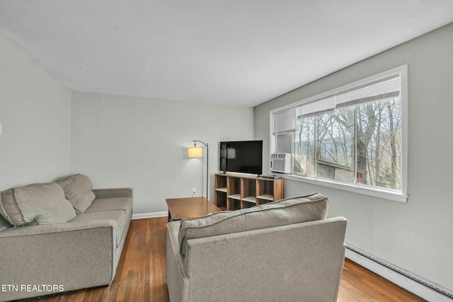 living room featuring baseboard heating and wood-type flooring