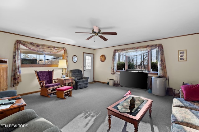 living room featuring a wealth of natural light, ornamental molding, and carpet floors