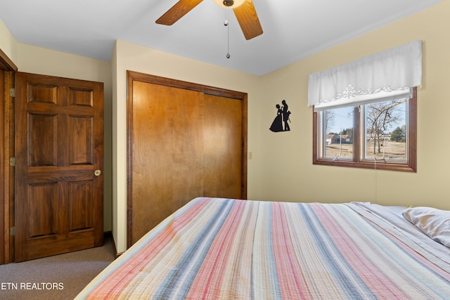 bedroom with a closet, ceiling fan, and light colored carpet