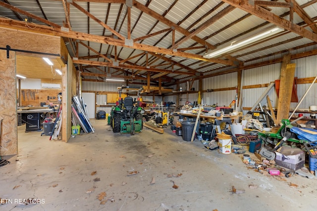 garage with a workshop area and an AC wall unit