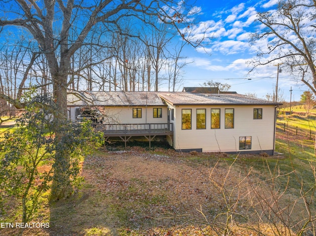 back of house featuring a deck