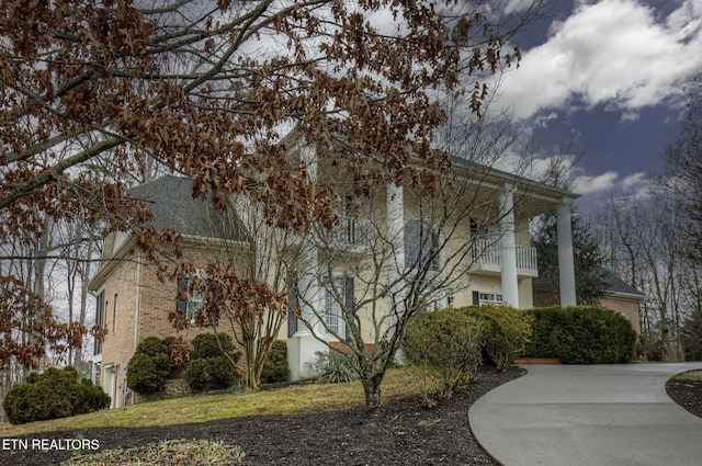 view of side of property with a balcony