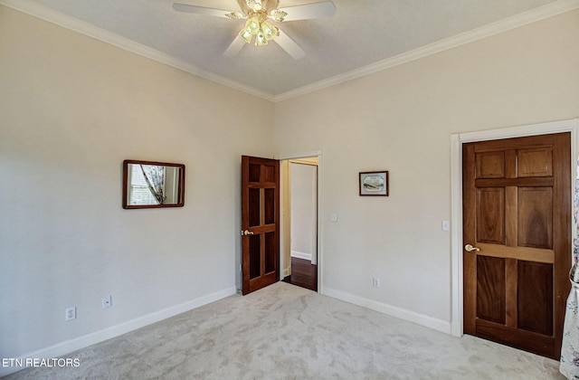 unfurnished bedroom with light carpet, crown molding, and ceiling fan