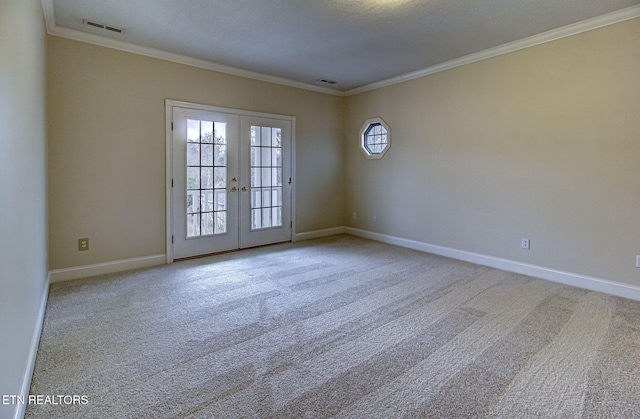 carpeted empty room with ornamental molding and french doors