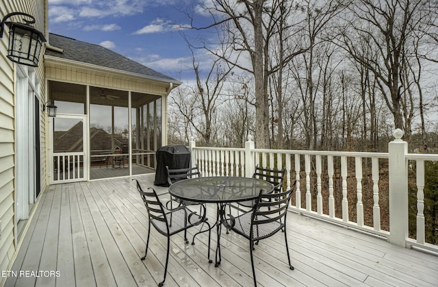 wooden terrace with grilling area and a sunroom