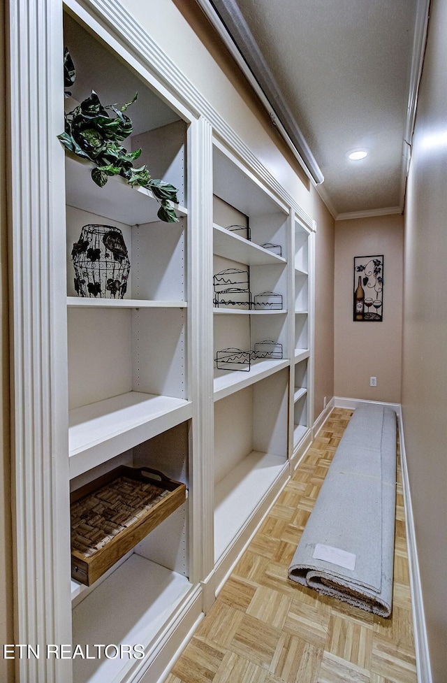 interior space with crown molding and light parquet floors