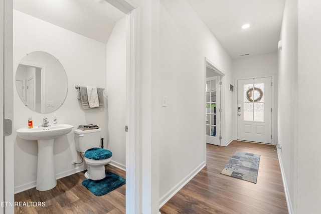 bathroom featuring sink, toilet, and hardwood / wood-style flooring