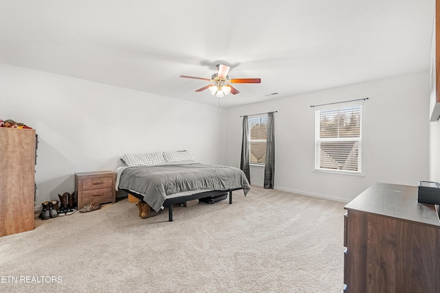 bedroom featuring light carpet and ceiling fan