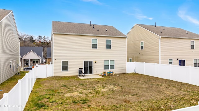 rear view of property featuring a patio area and a yard