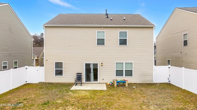 back of property featuring a yard and a patio