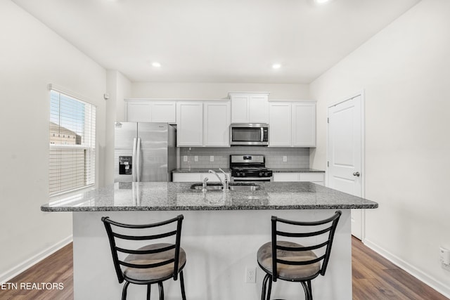 kitchen featuring sink, a kitchen island with sink, white cabinetry, and stainless steel appliances