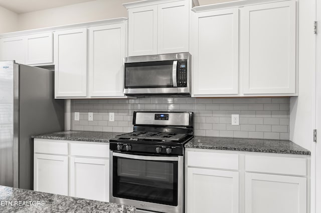 kitchen with backsplash, white cabinetry, and stainless steel appliances