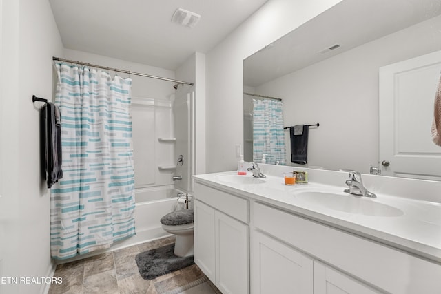 full bathroom with toilet, vanity, and shower / tub combo