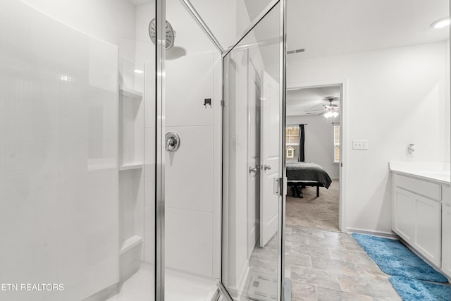 bathroom featuring vanity, ceiling fan, and walk in shower