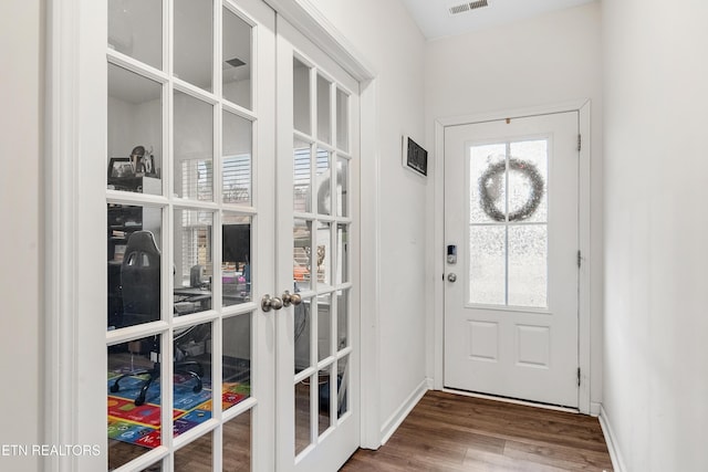 doorway with hardwood / wood-style flooring and french doors