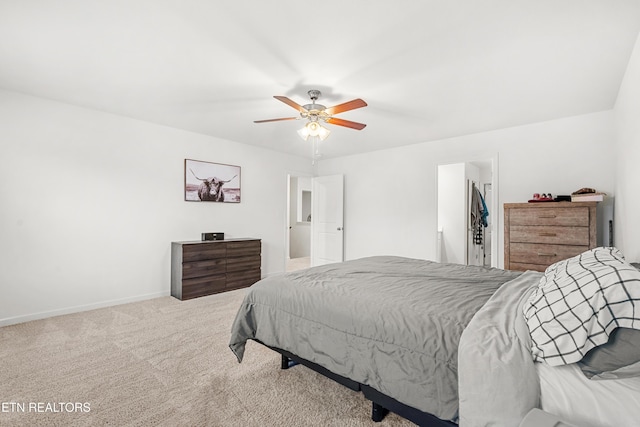 bedroom featuring ceiling fan, carpet, a spacious closet, and a closet