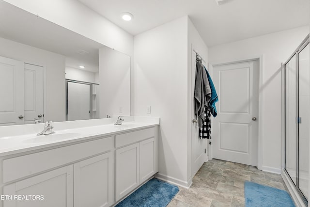 bathroom featuring an enclosed shower and vanity