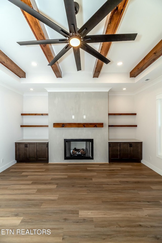 unfurnished living room with crown molding and dark wood-type flooring