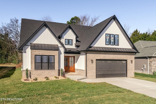 modern farmhouse with a front yard and a garage