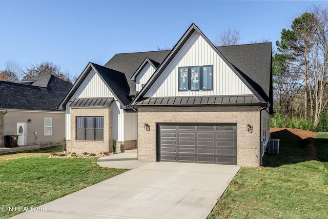 modern inspired farmhouse with a garage, cooling unit, and a front lawn