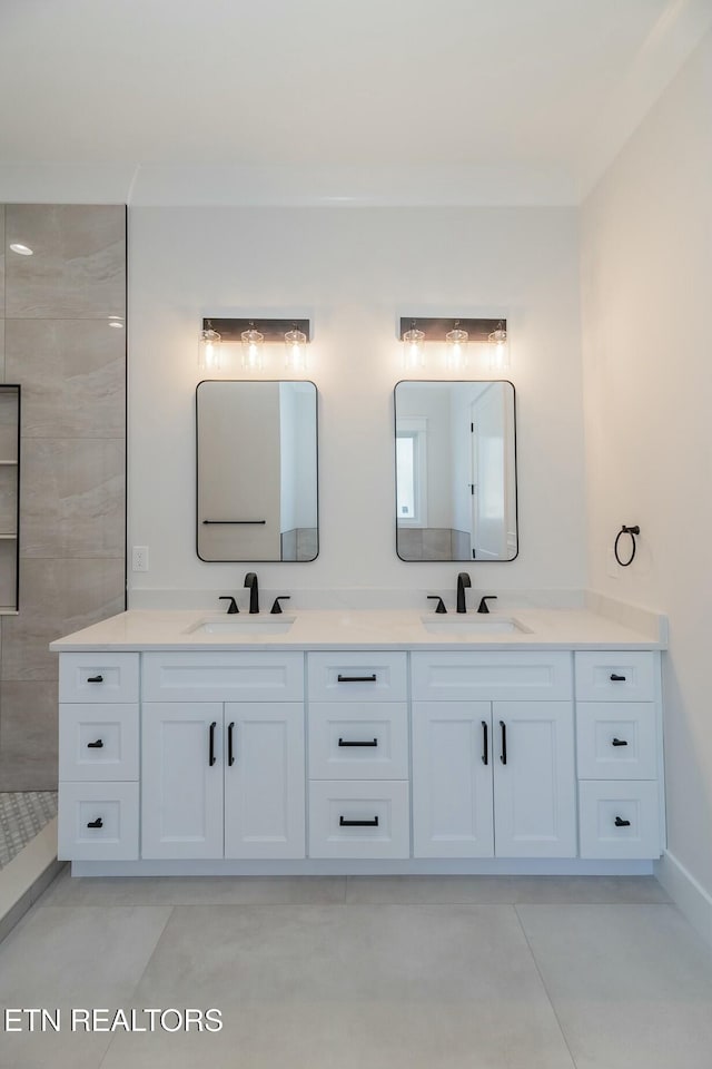 bathroom with vanity and a tile shower