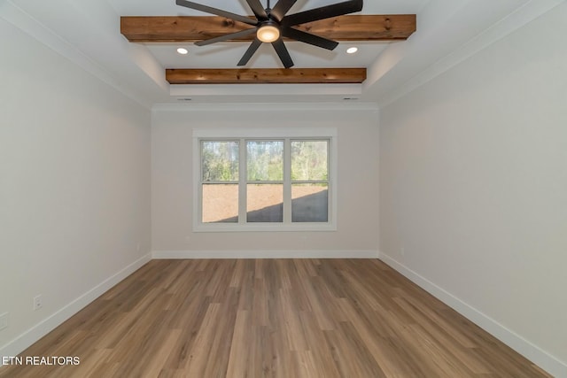 unfurnished room with light hardwood / wood-style floors, ceiling fan, and a raised ceiling