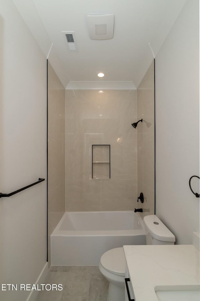 full bathroom featuring tiled shower / bath combo, toilet, tile patterned floors, and vanity