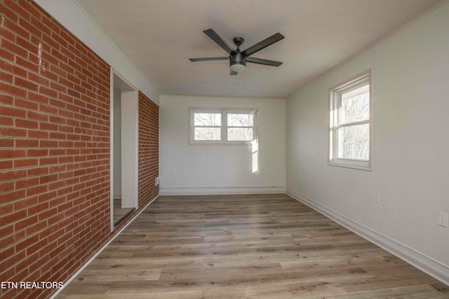 unfurnished sunroom featuring ceiling fan